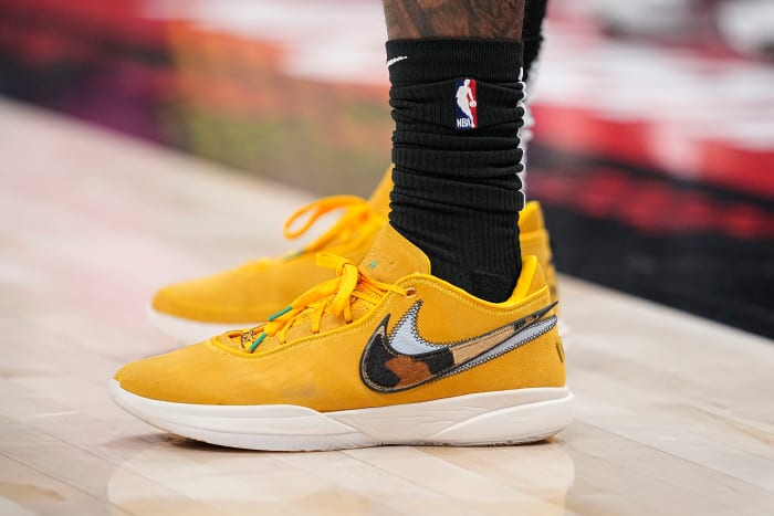 View of yellow and white Nike LeBron shoes.